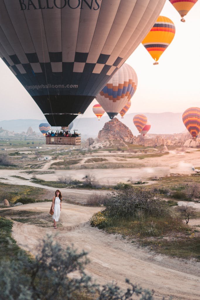 Woman Standing Under Hot Air Balloons